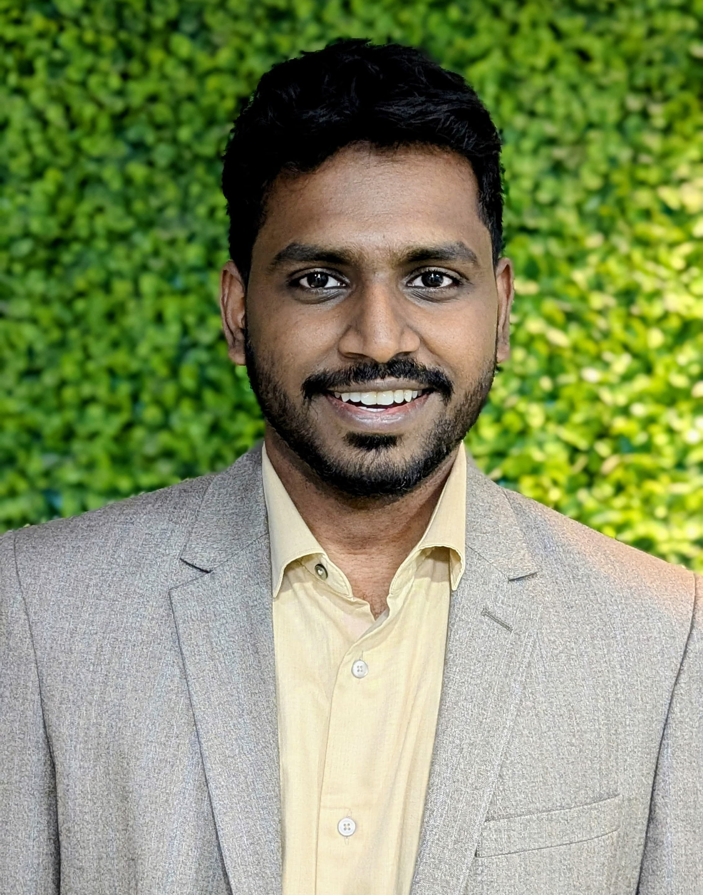 Nivesh in coat suit portrait